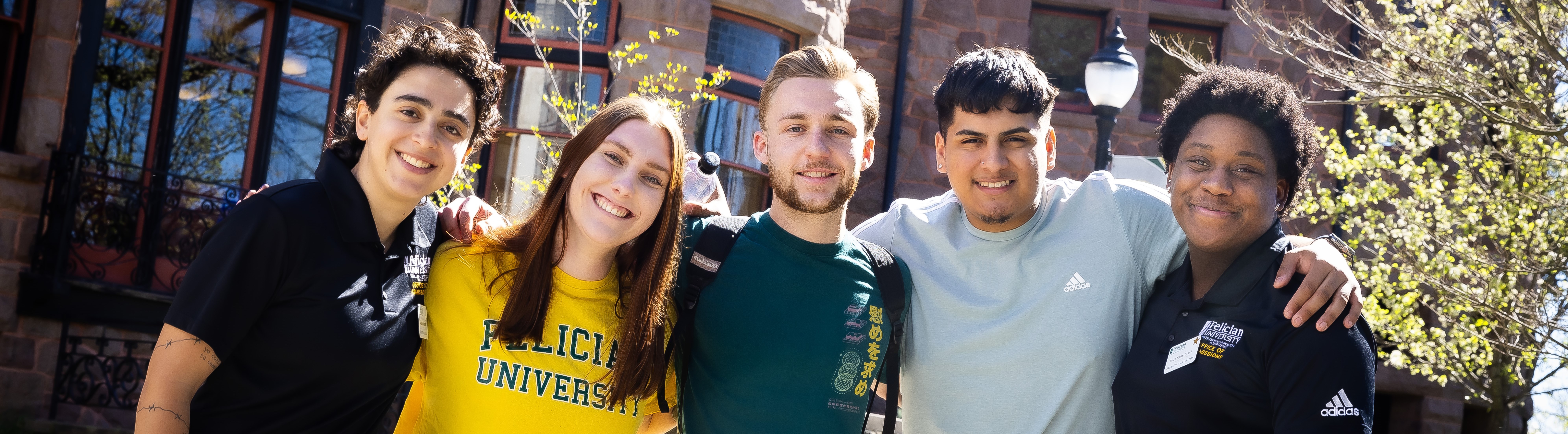 Students smiling wearing Felician shirts